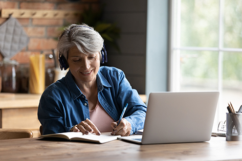 Woman with headphones at laptop